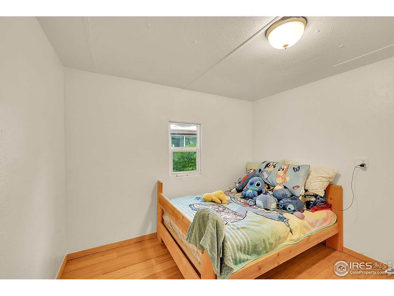 2500 East Harmony Road, Unit 178 Fort Collins, CO 80528 - Photo 6 of 22 a bed sitting in a bedroom next to a window