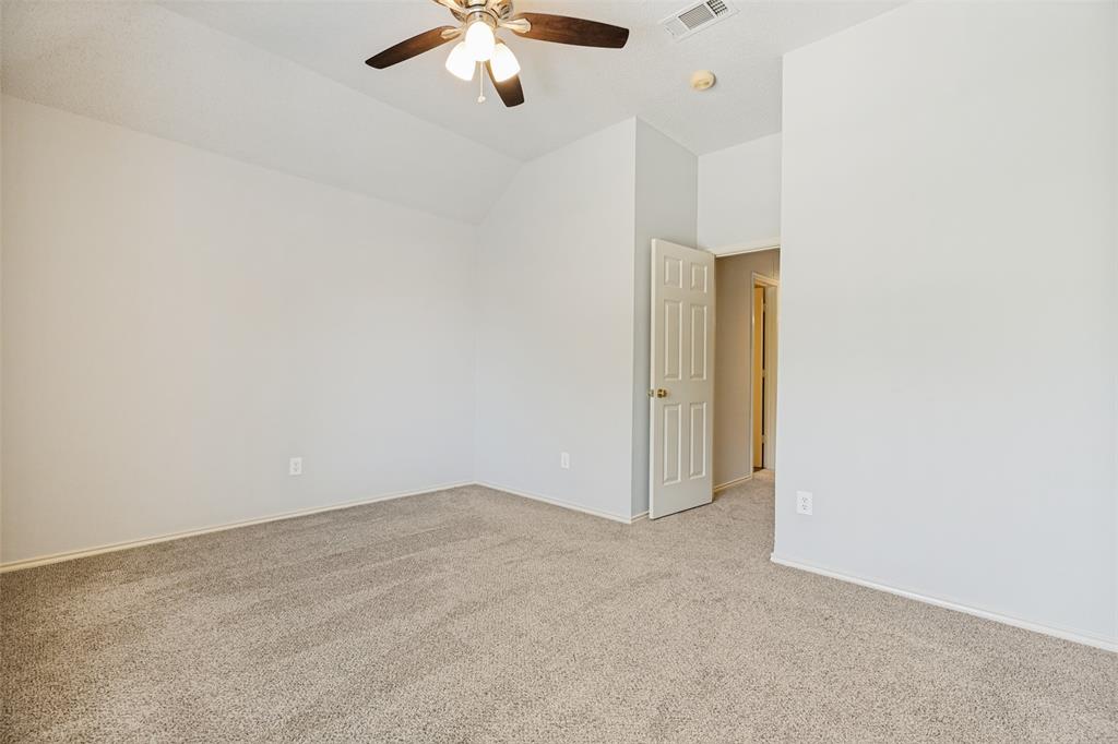 1215 Spring Creek Drive Allen, TX 75002 - Photo 25 of 40 Spacious room featuring vaulted ceilings, light gray wall paint, and neutral-toned carpeting