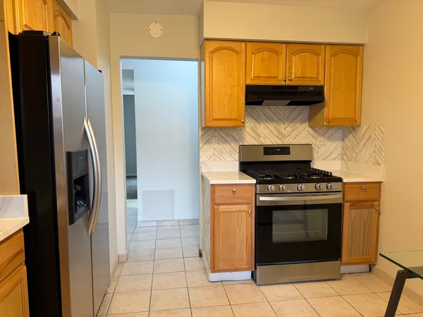a kitchen with a stove and a refrigerator