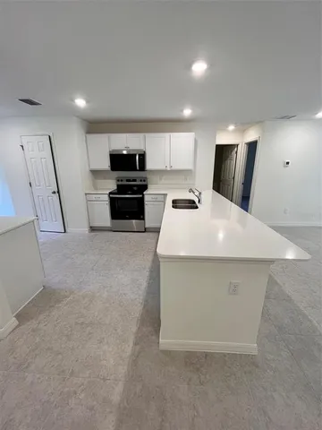 a kitchen with a sink a stove and refrigerator