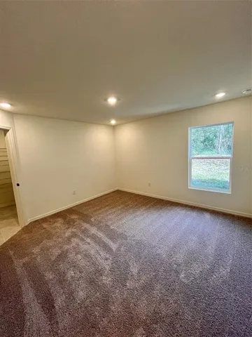 an empty room with a empty space and windows