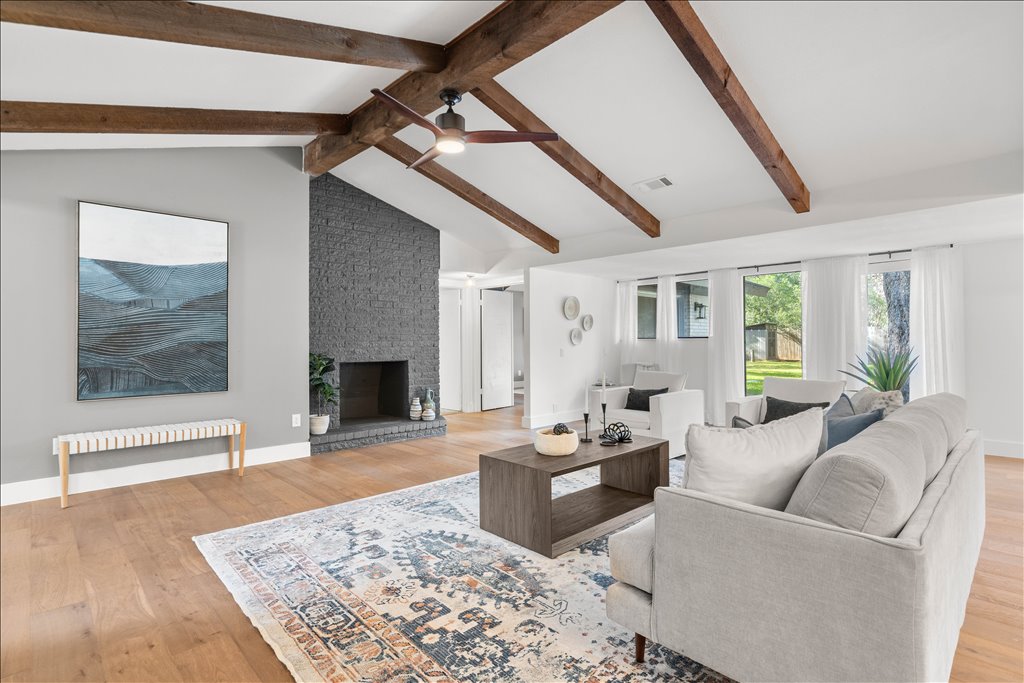 3402 Saddlestring Trail Austin, TX 78739 - Photo 11 of 33 Living room featuring light wood-style floors, a ceiling fan, radiator, and a fireplace