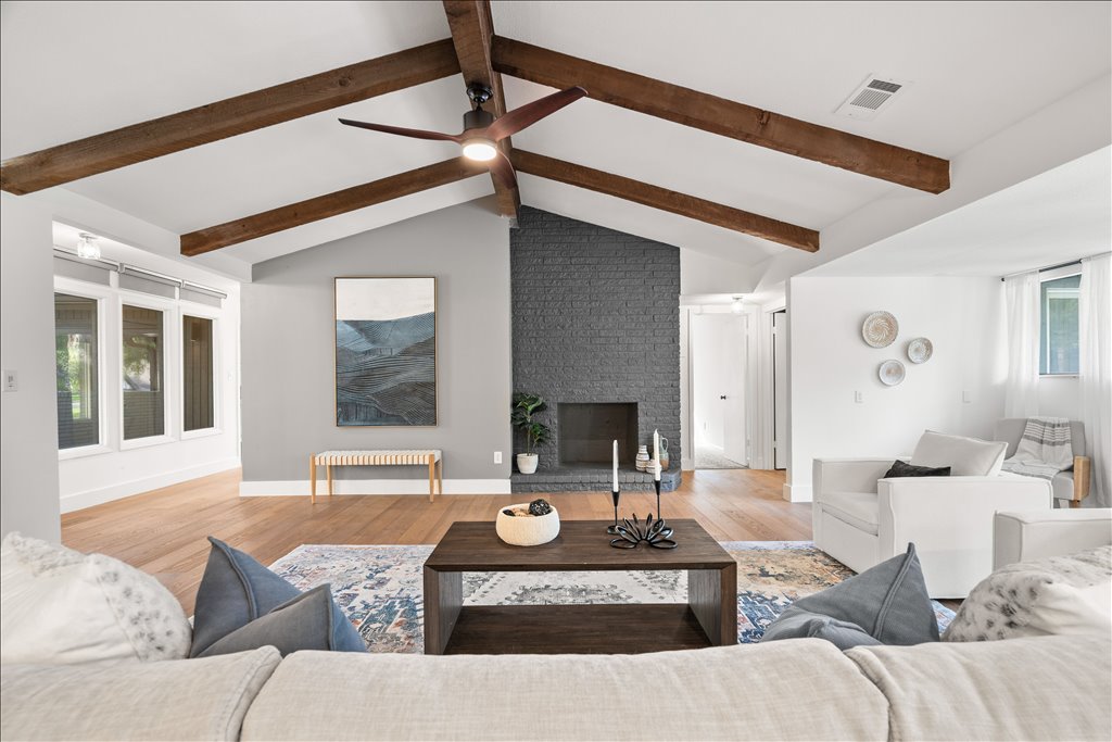 3402 Saddlestring Trail Austin, TX 78739 - Photo 12 of 33 Living room with light wood-style floors, a large fireplace, beamed ceiling, and ceiling fan