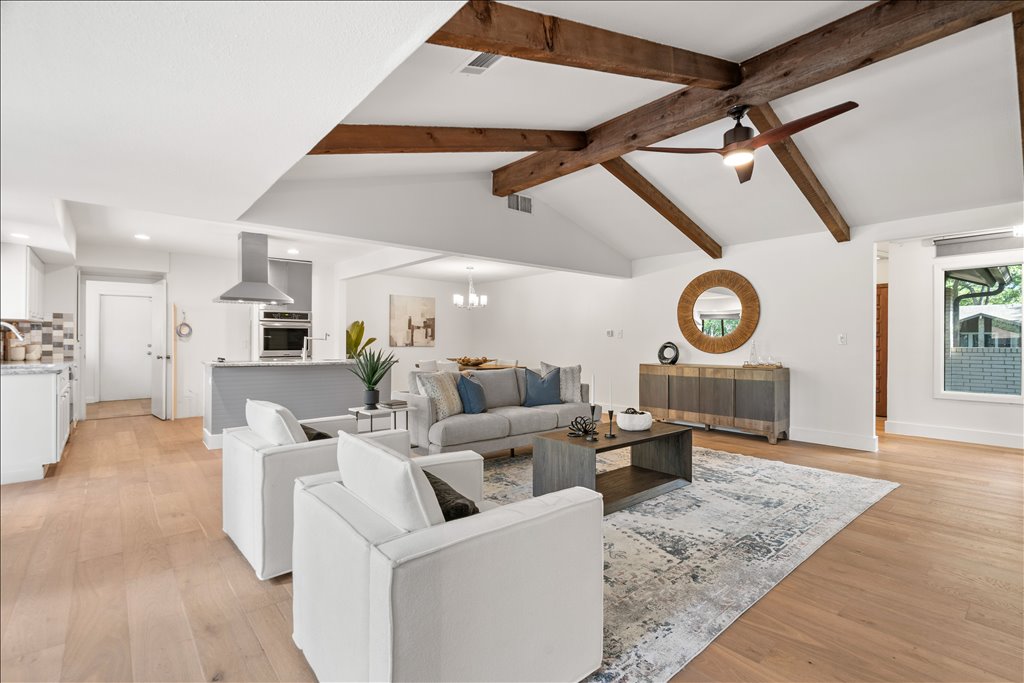 3402 Saddlestring Trail Austin, TX 78739 - Photo 13 of 33 Living room featuring light wood finished floors, hanging lights, a ceiling fan, and beamed ceiling