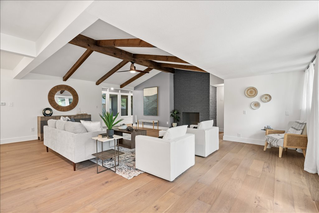 3402 Saddlestring Trail Austin, TX 78739 - Photo 14 of 33 Living area featuring light wood-type flooring, beamed ceiling, and a brick fireplace