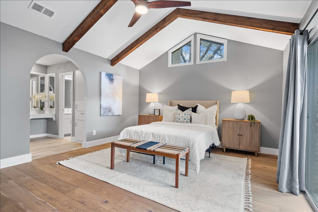 3402 Saddlestring Trail Austin, TX 78739 - Photo 21 of 33 Bedroom with beamed ceiling, light wood-style floors, ceiling fan, arched walkways, and connected bathroom