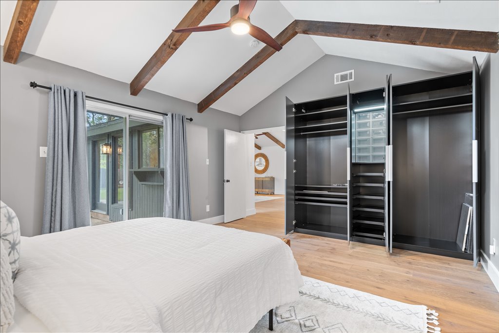 3402 Saddlestring Trail Austin, TX 78739 - Photo 23 of 33 Bedroom featuring ceiling fan, light wood-style flooring, access to exterior, and a high ceiling