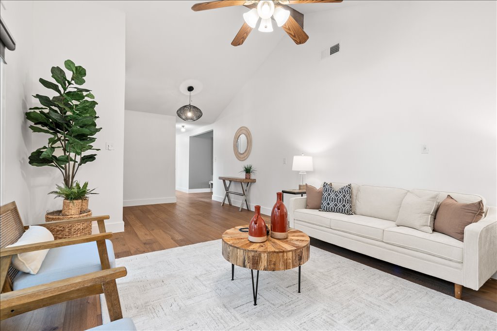 3402 Saddlestring Trail Austin, TX 78739 - Photo 9 of 33 Living area featuring lofted ceiling, wood finished floors, and a ceiling fan