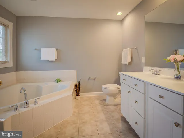 a kitchen with stainless steel appliances granite countertop a sink a stove a refrigerator and cabinets