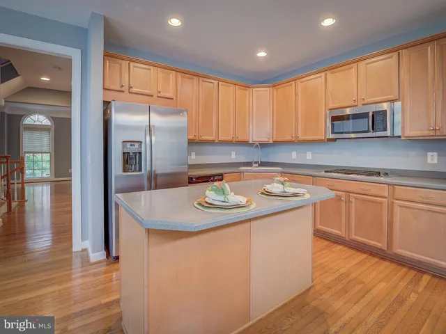 a kitchen with a stove a sink a dining table and chairs