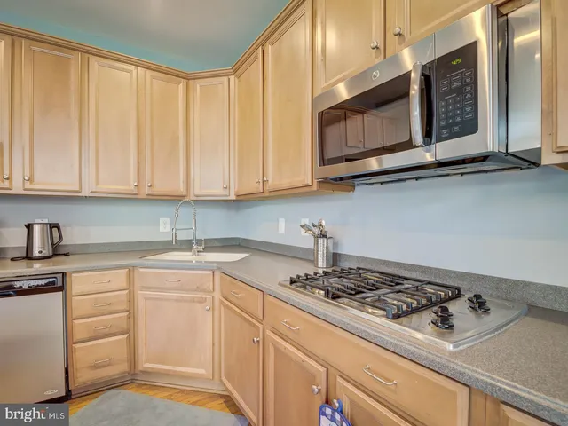 a living room with furniture a flat screen tv and a large window