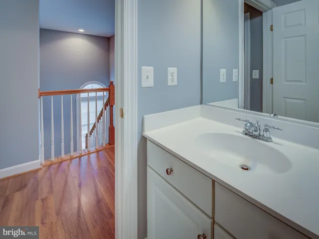 a bathroom with a sink a mirror and a toilet