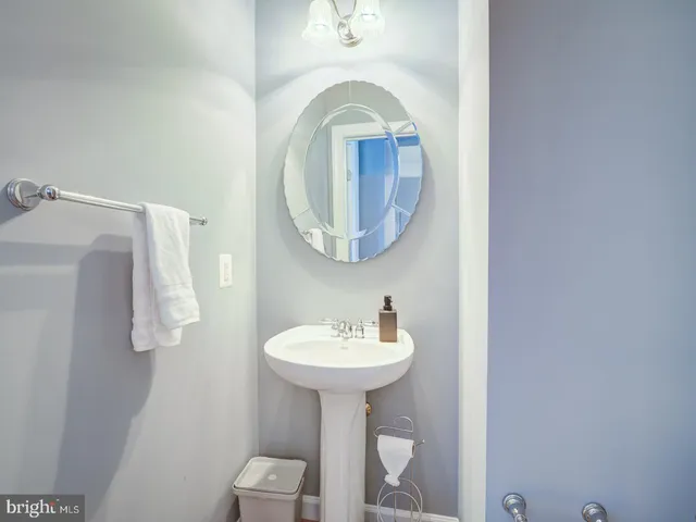 a bedroom with a large bed and wooden floor