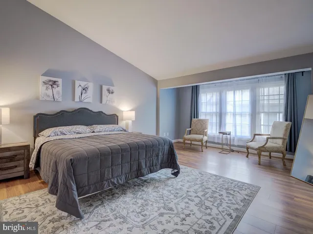 a bedroom with a bed and a couch