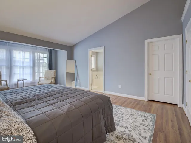 a bedroom with a bed and a couch