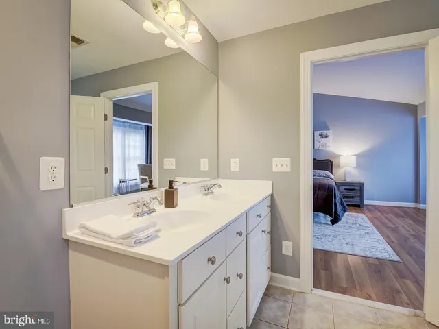 a bathroom with a sink toilet and a mirror