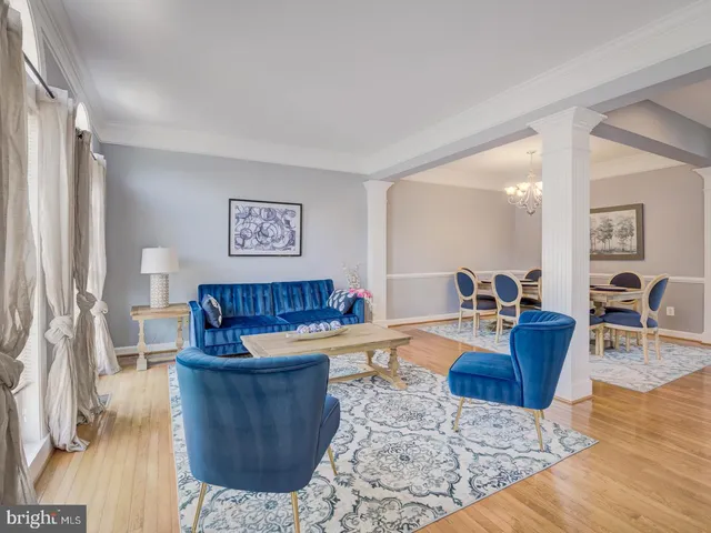 a living room with furniture a lamp and a window