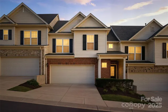 a front view of a house with a garage and balcony