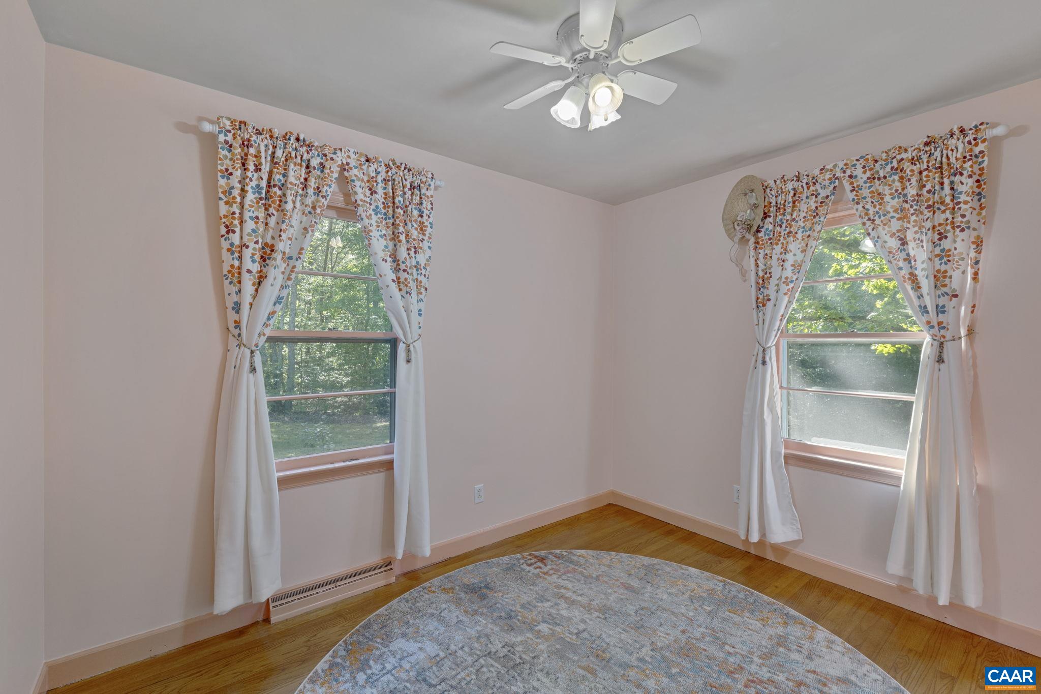 9020 West River Road Palmyra, VA 22963 - Photo 17 of 41 a view of empty room with wooden floor and fan