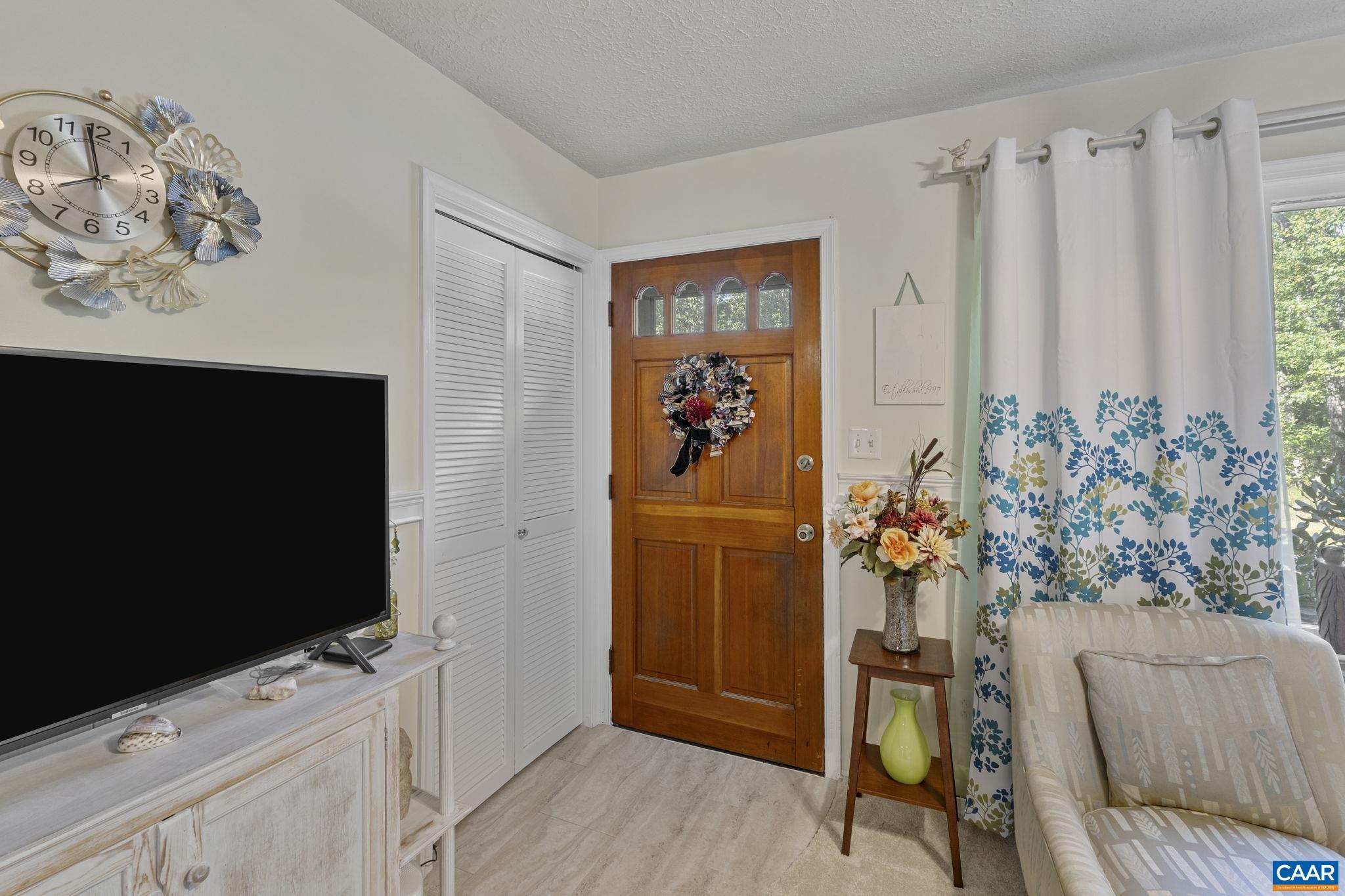 9020 West River Road Palmyra, VA 22963 - Photo 2 of 41 a living room with furniture and a flat screen tv