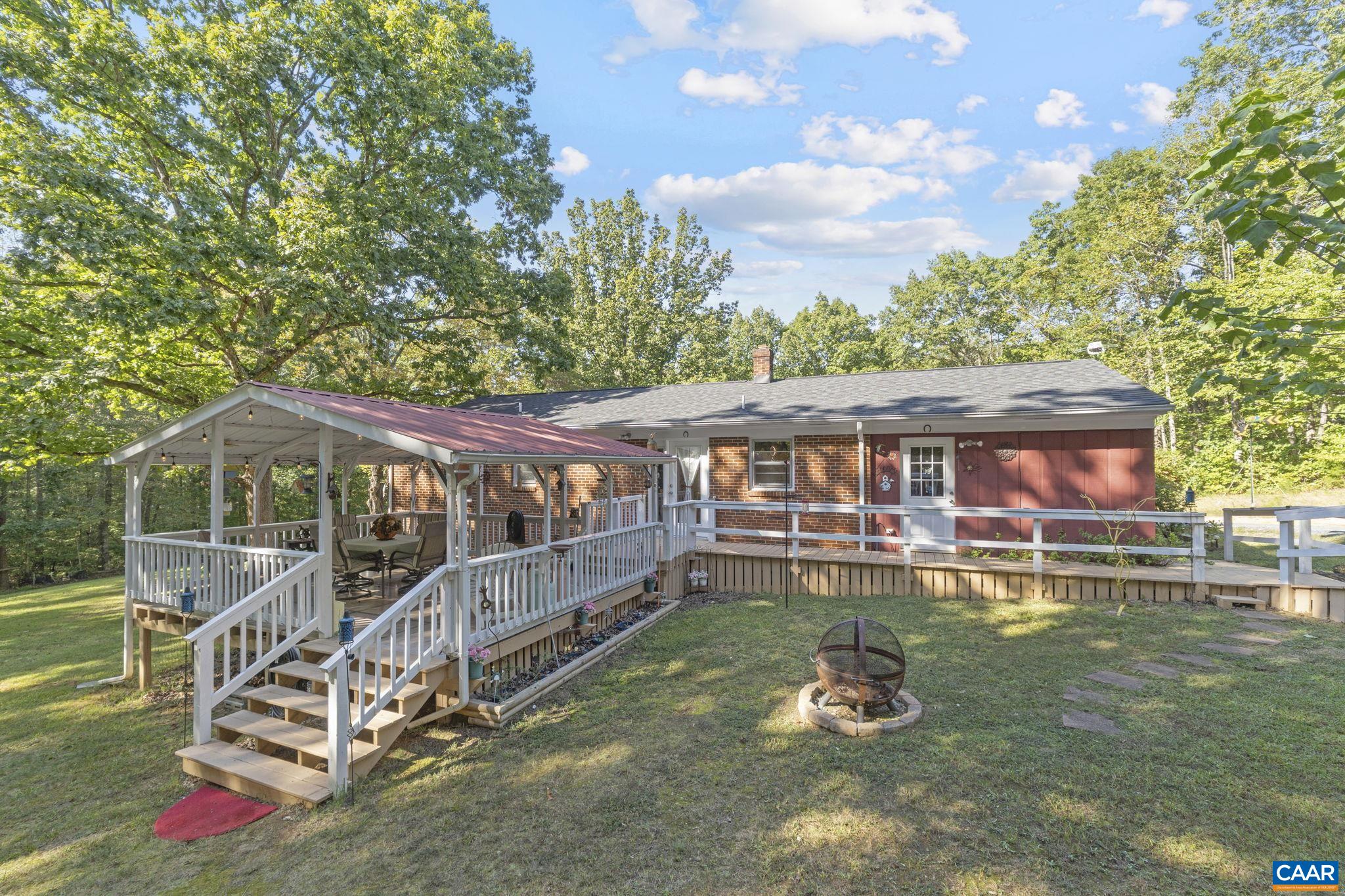 9020 West River Road Palmyra, VA 22963 - Photo 22 of 41 a backyard of a house with yard table and chairs
