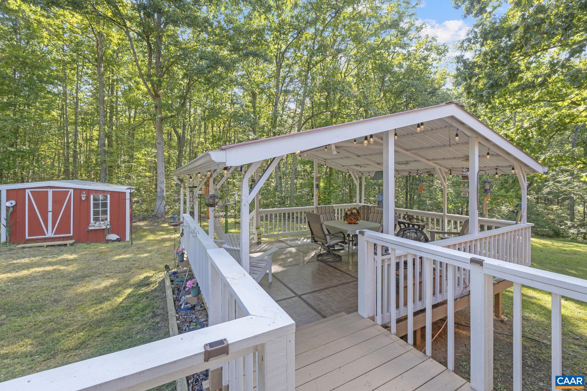 9020 West River Road Palmyra, VA 22963 - Photo 25 of 41 a view of a wooden deck and a backyard