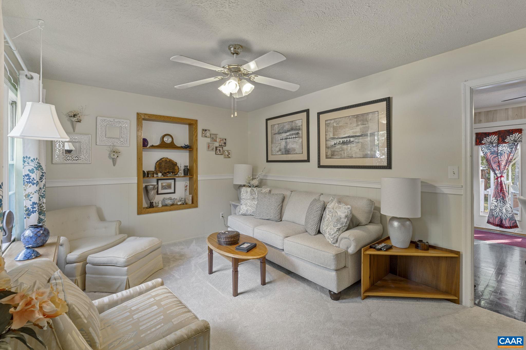 9020 West River Road Palmyra, VA 22963 - Photo 4 of 41 a living room with furniture and a painting on the wall
