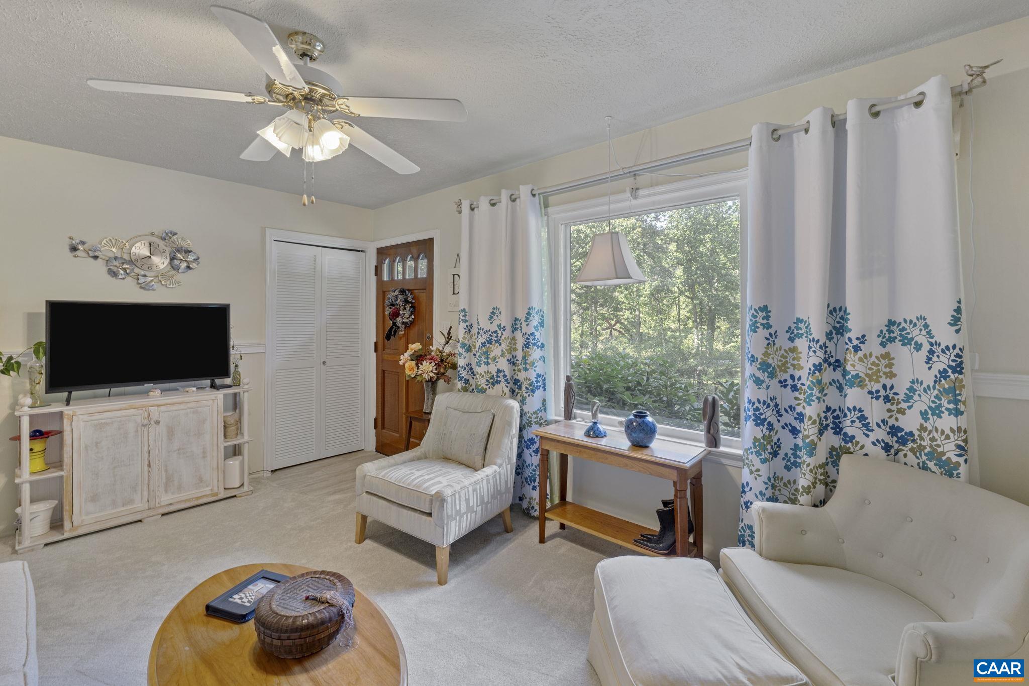 9020 West River Road Palmyra, VA 22963 - Photo 5 of 41 a living room with furniture and a flat screen tv