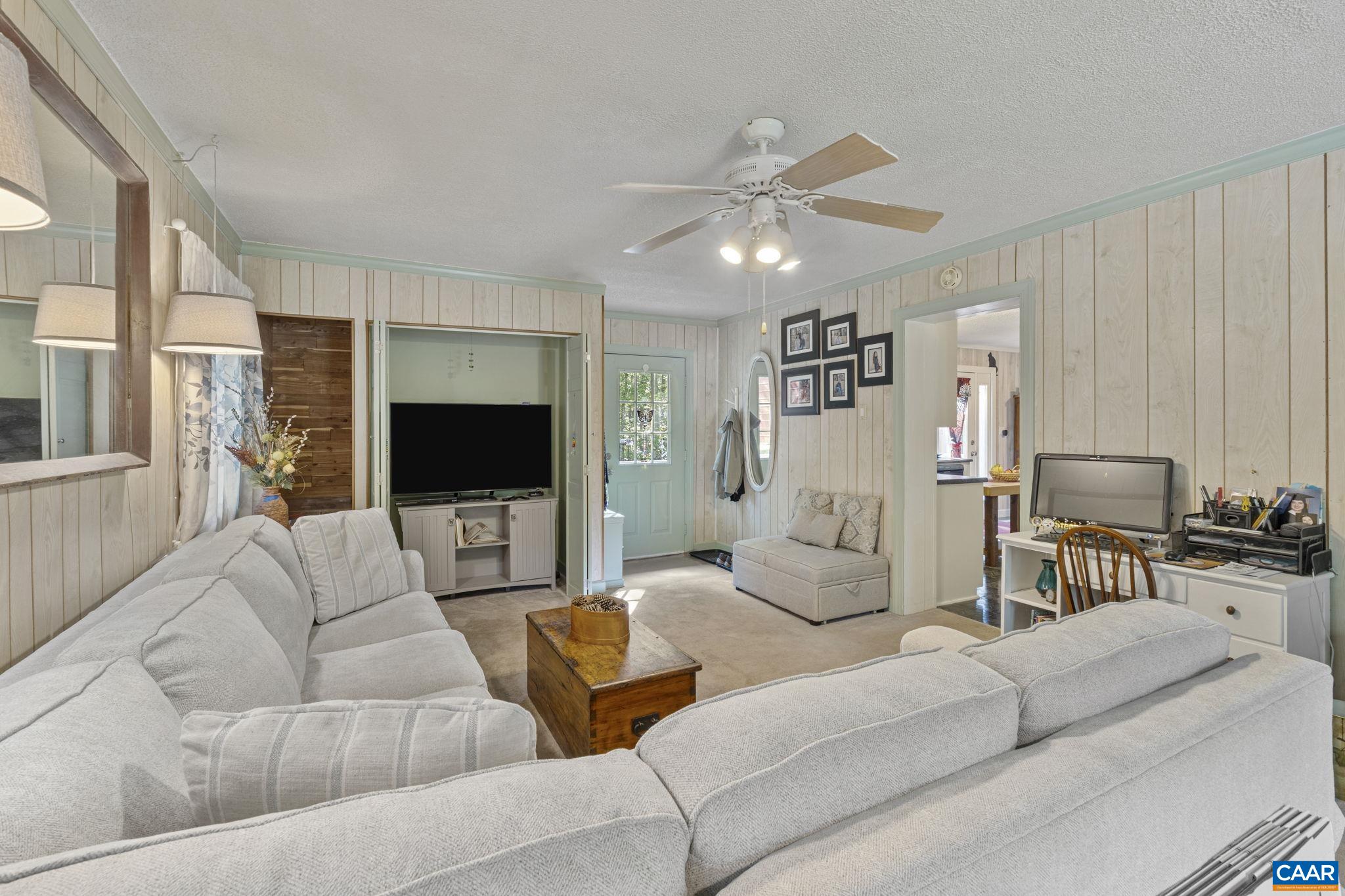 9020 West River Road Palmyra, VA 22963 - Photo 7 of 41 a living room with furniture and a flat screen tv