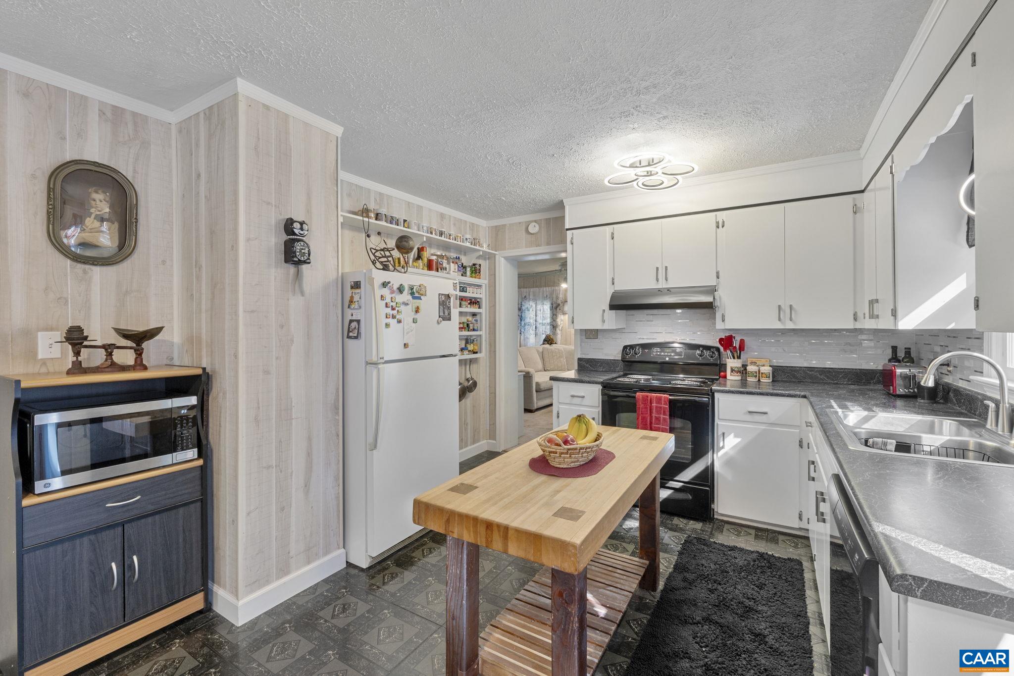 9020 West River Road Palmyra, VA 22963 - Photo 10 of 41 a kitchen with stainless steel appliances a stove a sink and a refrigerator
