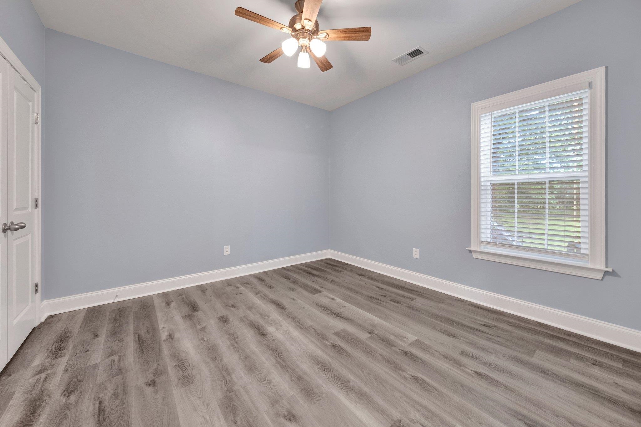 8077 Ellis Road Bartlett, TN 38133 - Photo 18 of 29 Unfurnished room with ceiling fan, wood finished floors, and baseboards