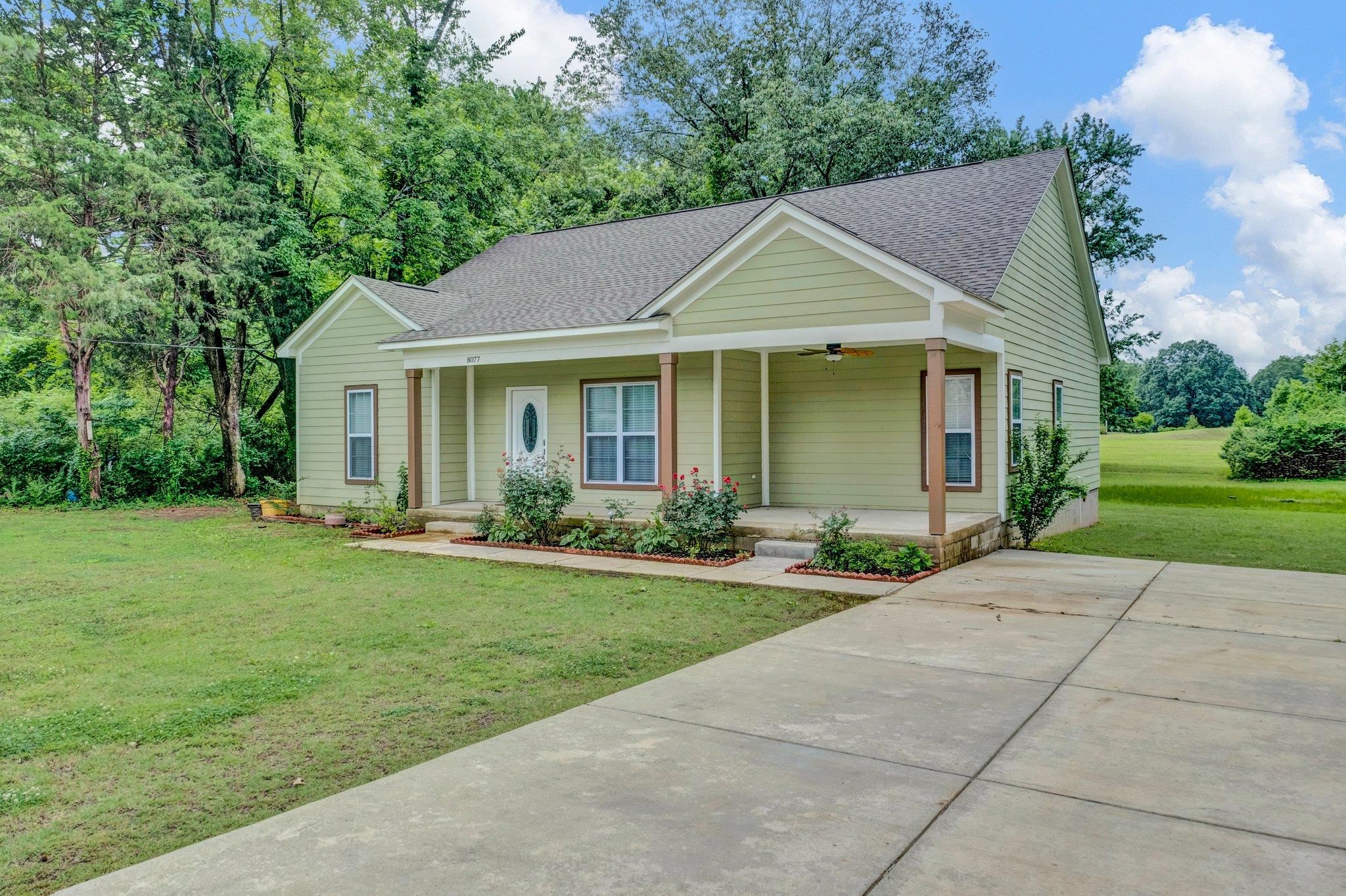 8077 Ellis Road Bartlett, TN 38133 - Photo 4 of 29 View of front of home with covered porch, a front yard, a shingled roof, and a ceiling fan
