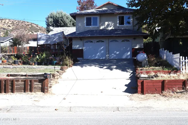 a view of a house with a snow in the background
