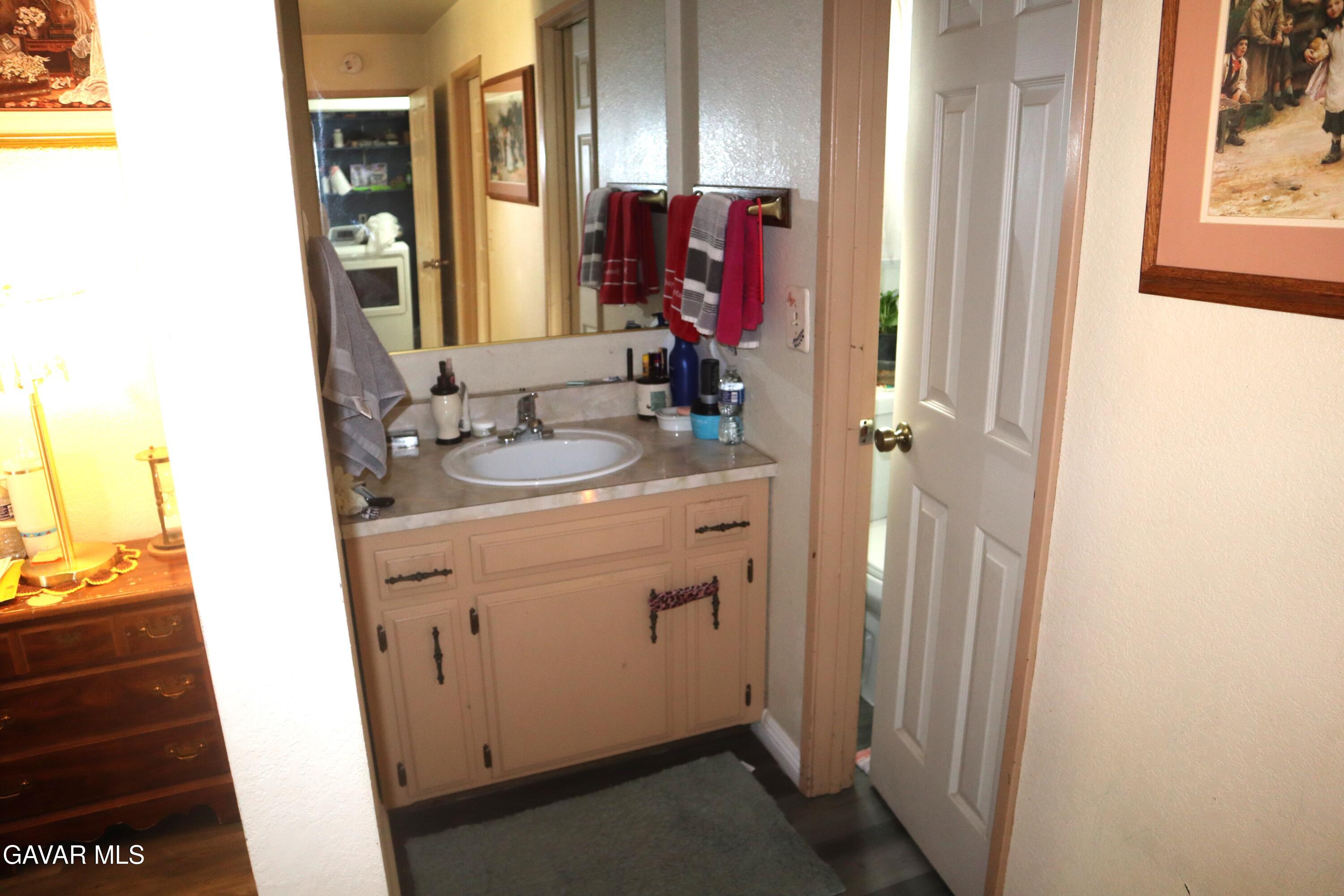 14955 Elizabeth Lake Road Lake Hughes, CA 93532 - Photo 12 of 17 a bathroom with a sink vanity and a mirror