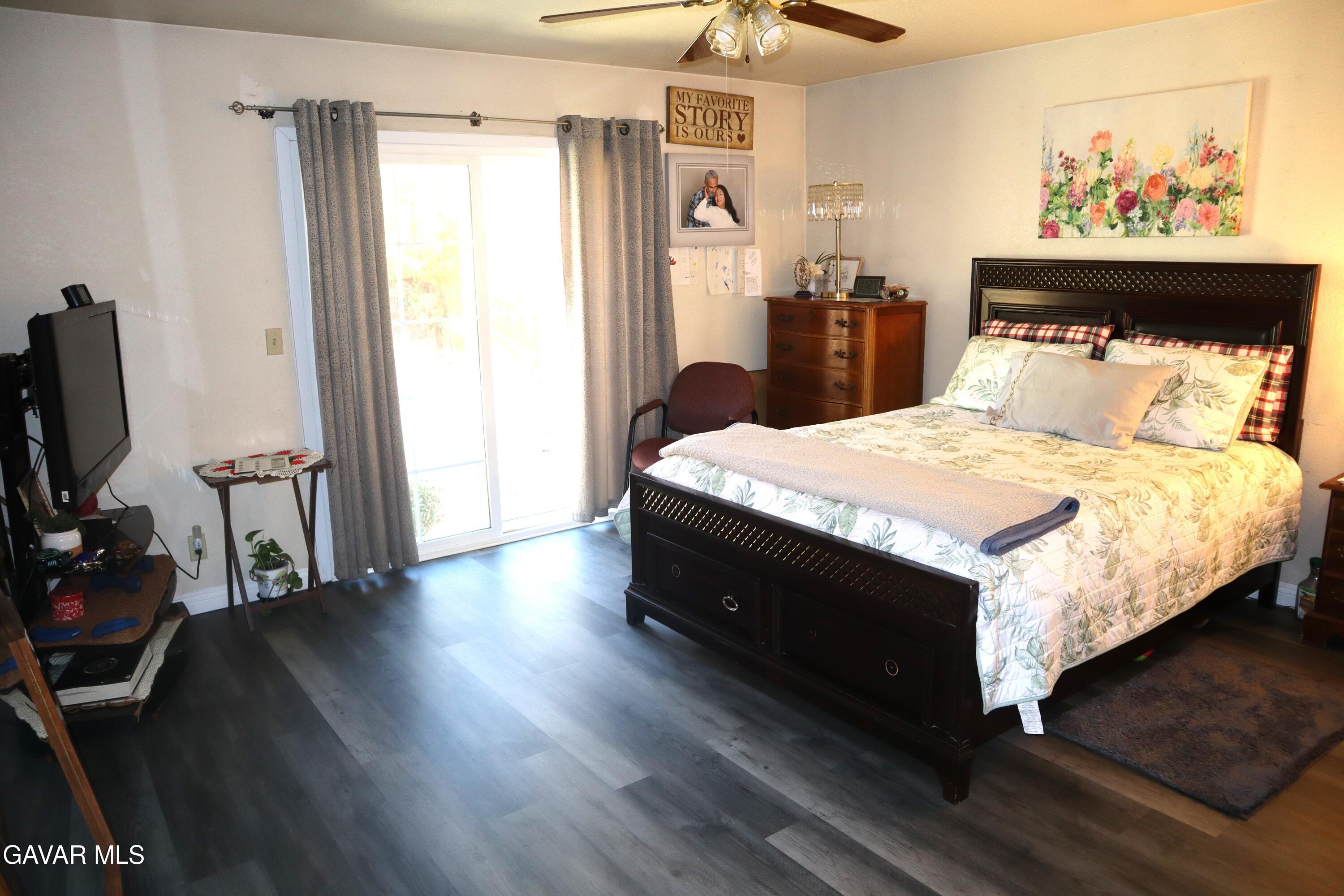 14955 Elizabeth Lake Road Lake Hughes, CA 93532 - Photo 13 of 17 a bedroom with bed and wooden floor