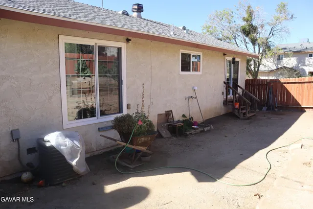 a view of a patio with table and chairs and potted plants