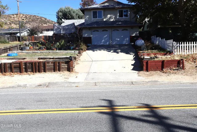 a view of a house with a yard and covered with snow