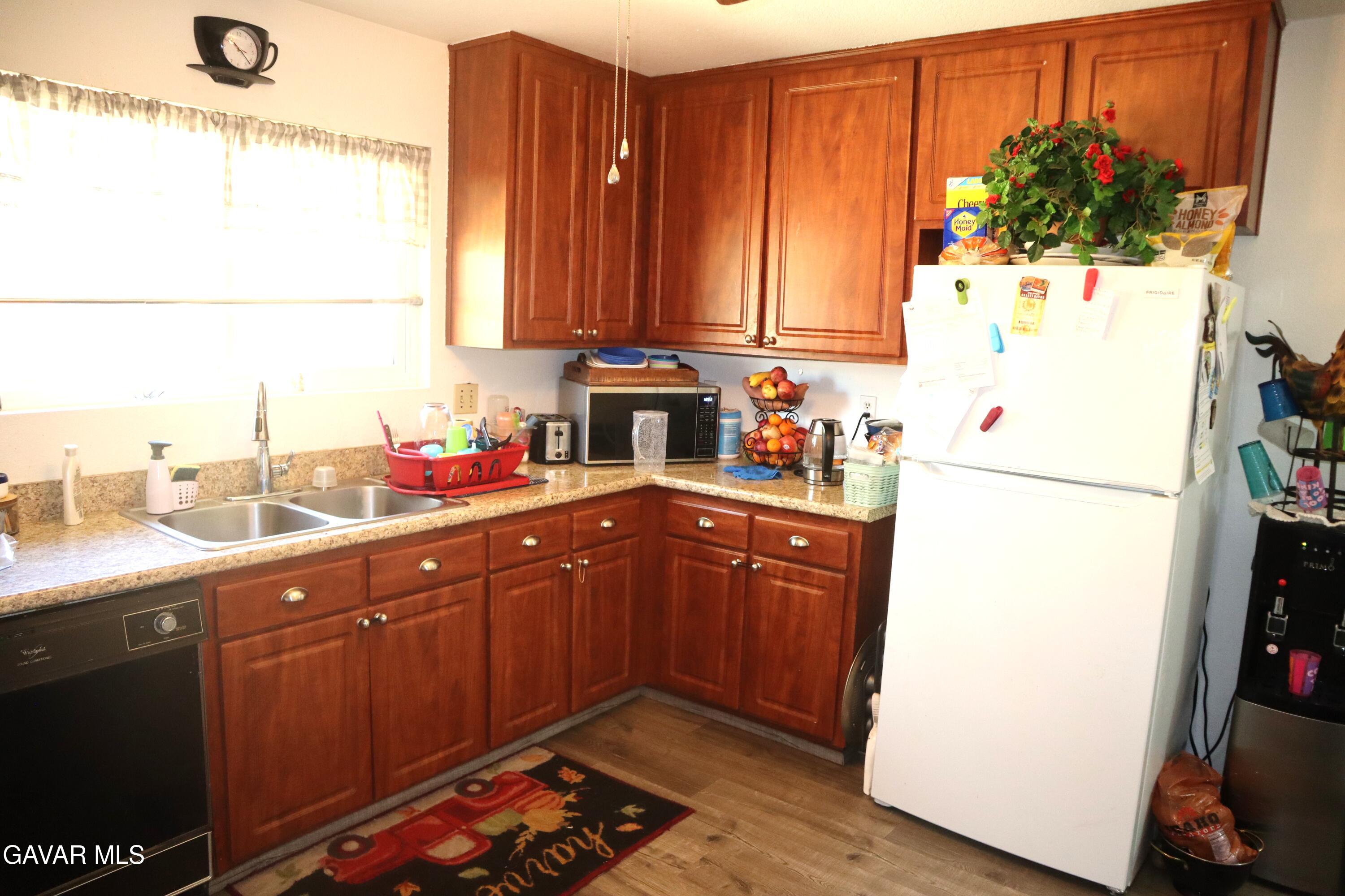 14955 Elizabeth Lake Road Lake Hughes, CA 93532 - Photo 6 of 17 a kitchen with a refrigerator and a sink