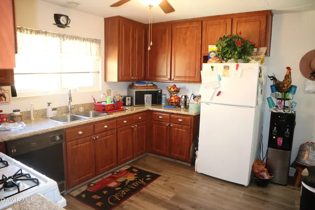 a kitchen with sink a refrigerator and a stove
