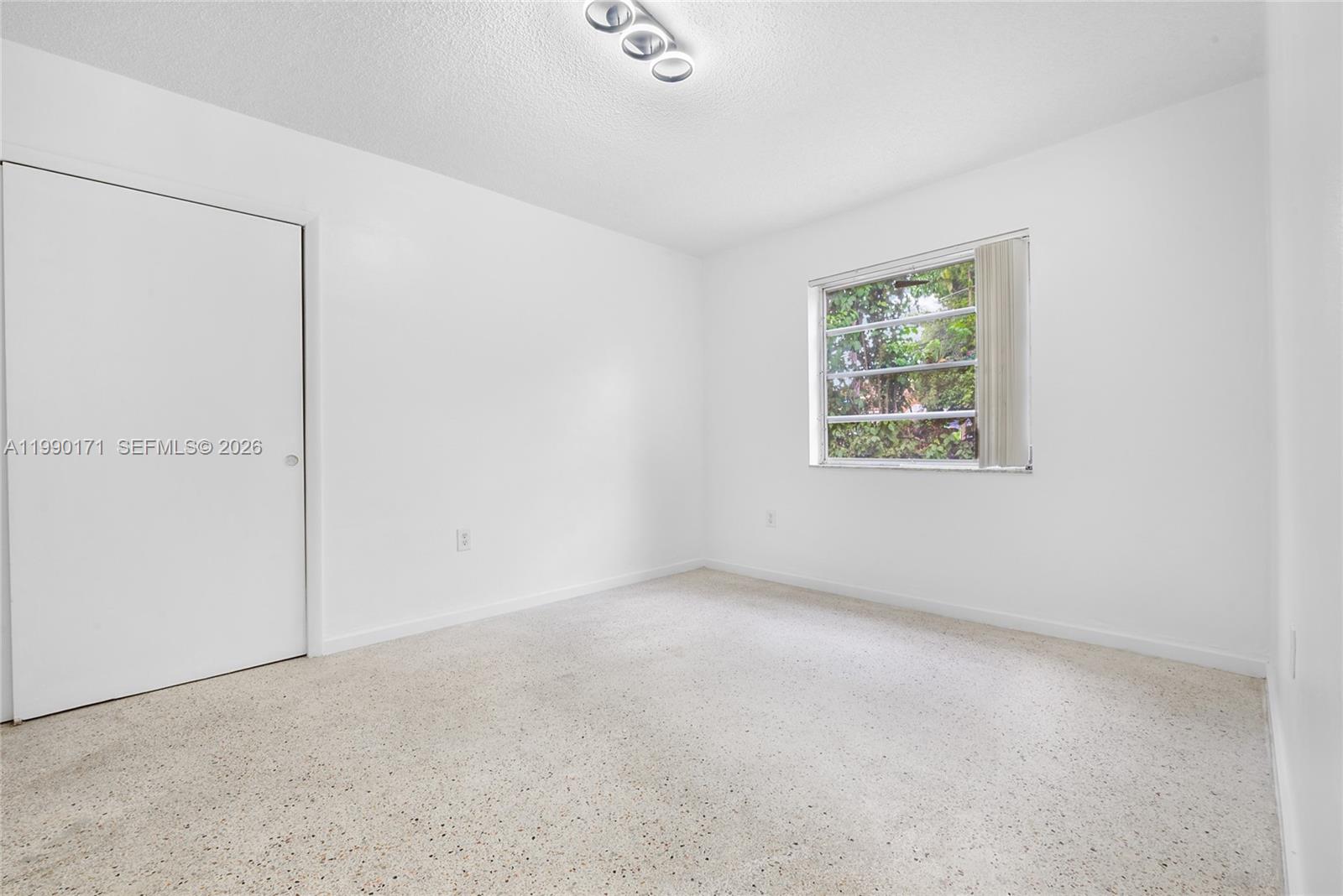 2661 Southwest 11th Street, Unit 8 Miami, FL 33135 - Photo 5 of 9 an empty room with windows