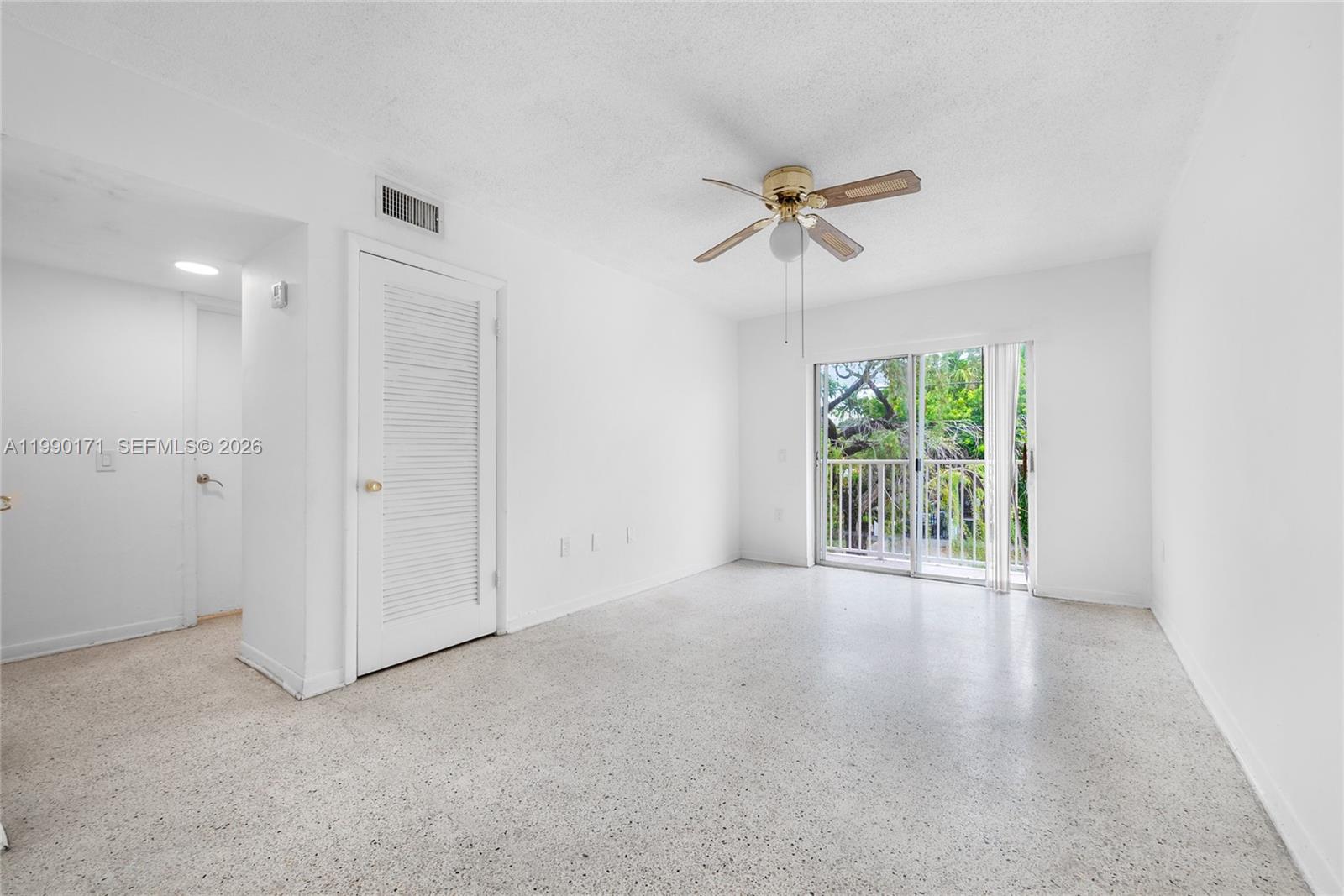 2661 Southwest 11th Street, Unit 8 Miami, FL 33135 - Photo 6 of 9 an empty room with windows and closet