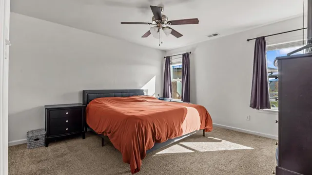 a bed sitting in a bedroom next to a window