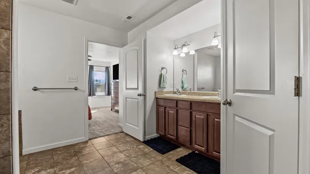 a bathroom with a double vanity sink shower and a mirror