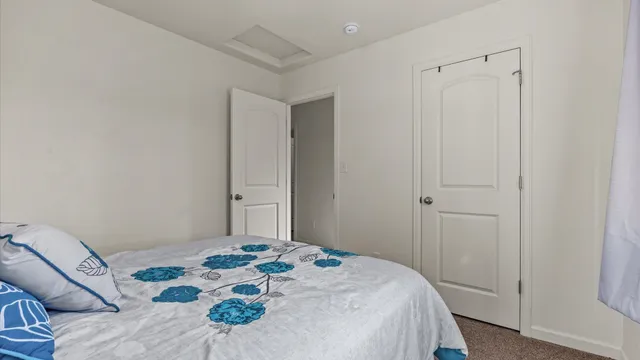 a bedroom with a bed and a table in it