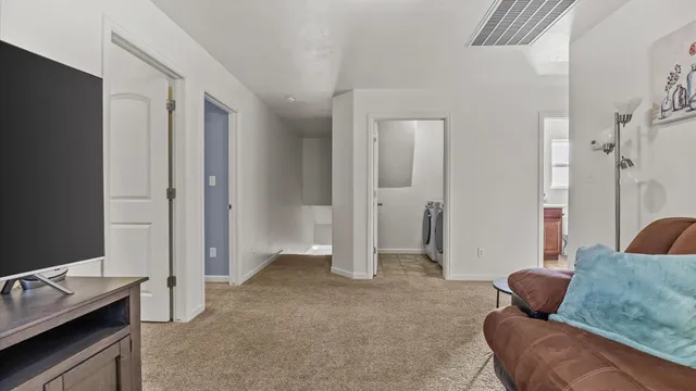 a living room with furniture and a air conditioner vent