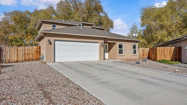 front view of a house with a yard and garage