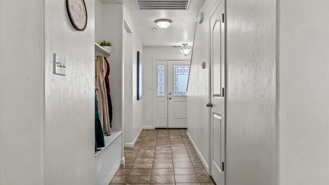 a bathroom with a glass shower door and a mirror