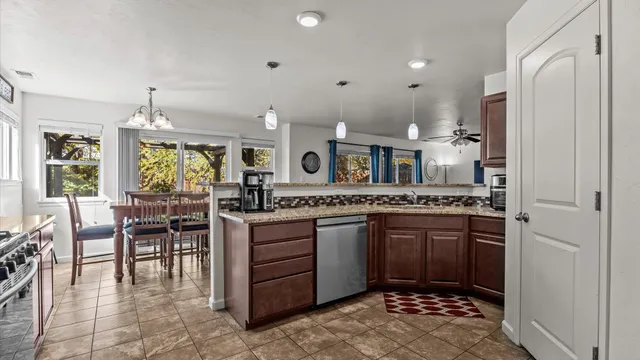 a large kitchen with kitchen island granite countertop a sink and cabinets