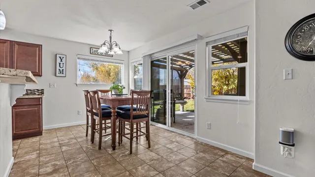 a view of a dining room with furniture and chandelier