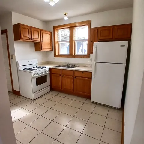 a kitchen with a stove a refrigerator and a sink